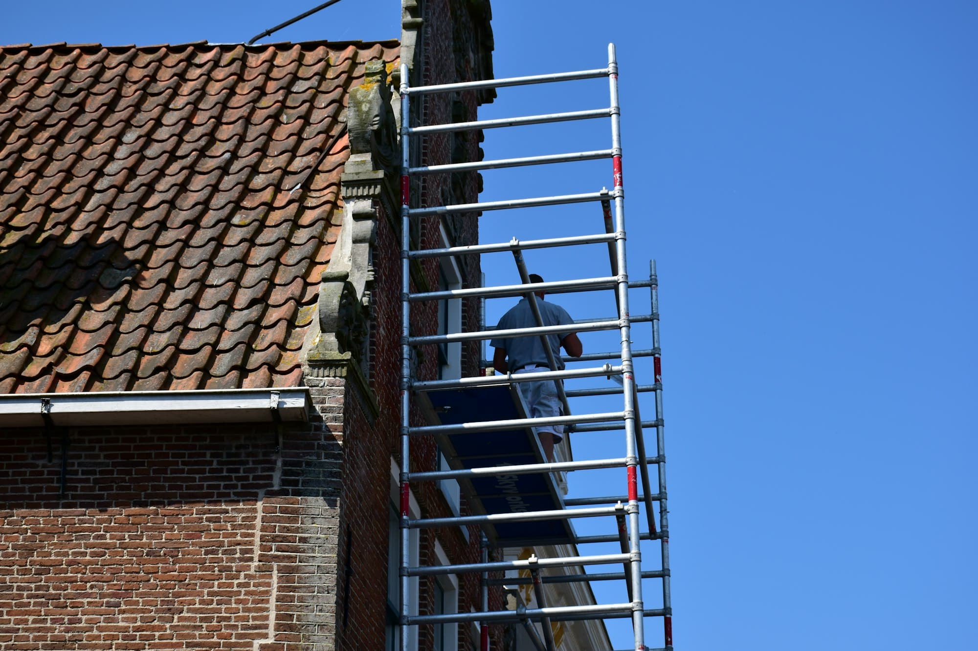Scaffolding against the brick facade of a commercial building