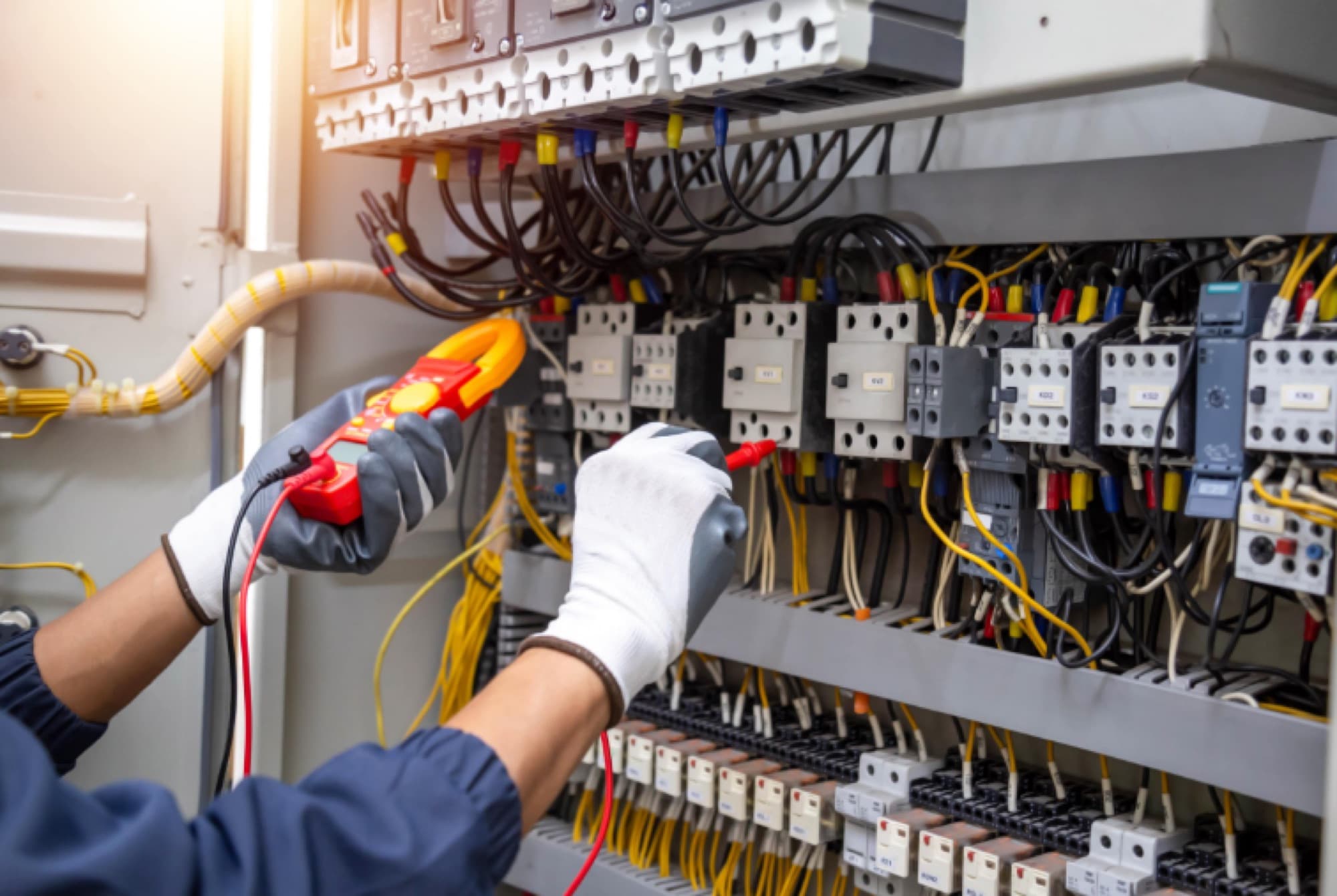 Engineer testing circuits in a commercial electrical distribution board