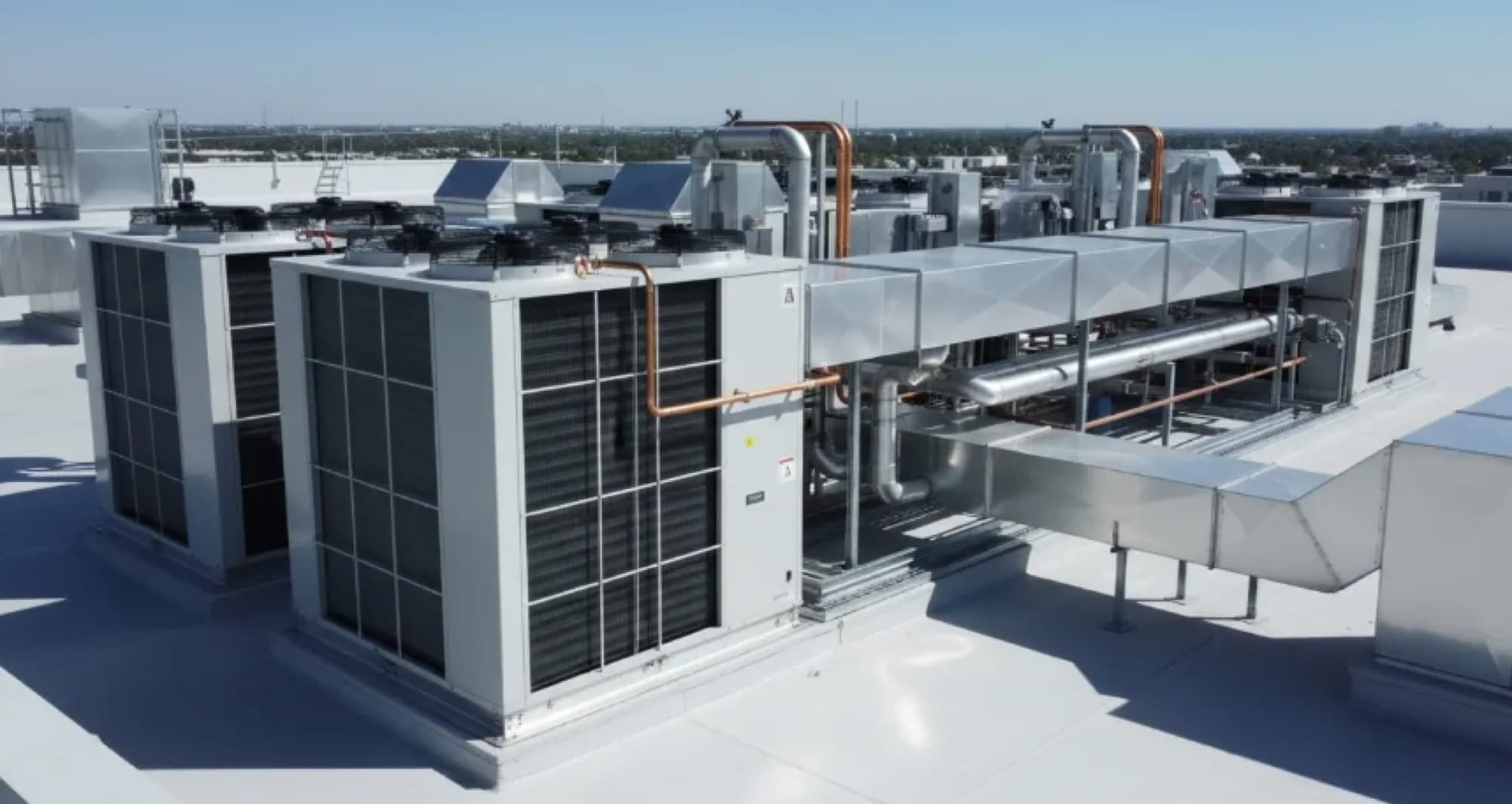 Rooftop HVAC plant — packaged units and ductwork on a commercial roof
